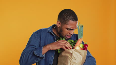 person counting all his freshly harvested produce in a paper bag