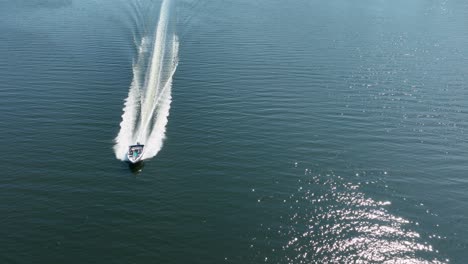 drone shot of a motorboat speeding through the puget sound