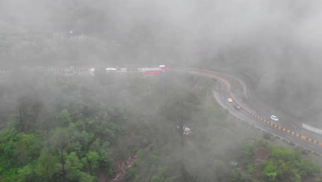 aerial birds of muree expressway through misty foggy trees in punjab