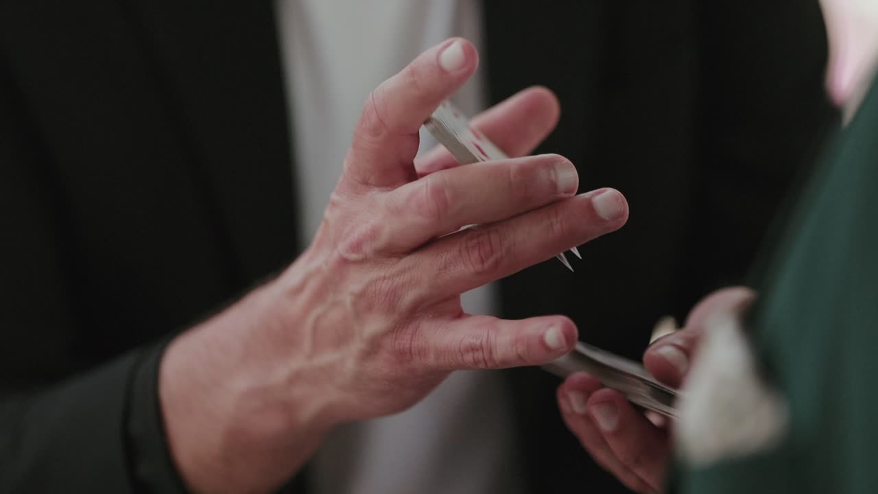 manipulating cards mid trick in close up hand movement detail