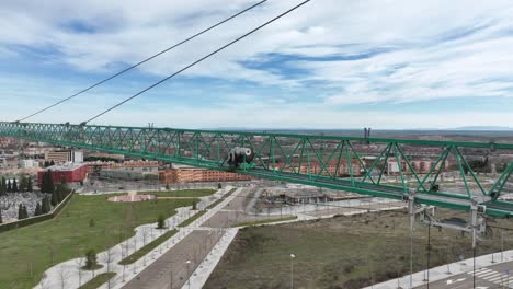 aerial close up view of the arm of a green construction crane