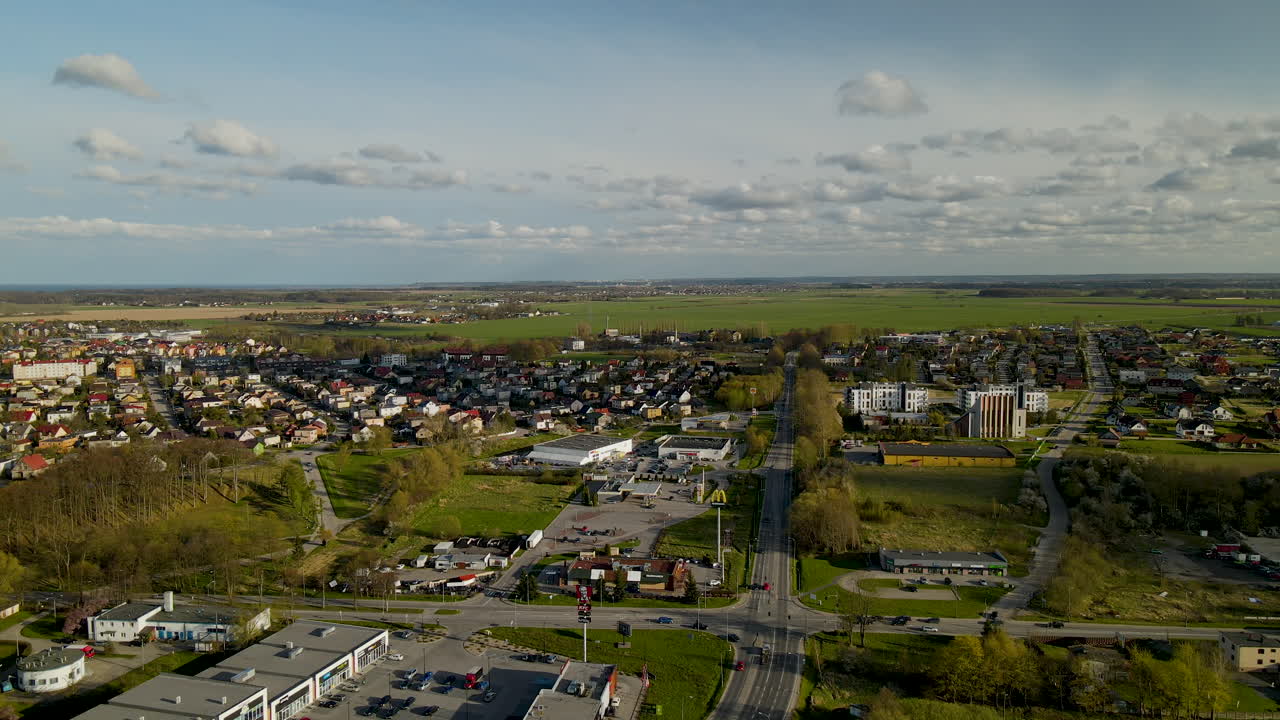 Descending shot of Puck Village in Poland during beautiful sunset with roads and housing area