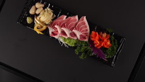 a beautifully plated fresh fish sashimi with a delicate texture and rich umami flavor. 섬세한 식감과 풍부한 감칠맛을 지닌 아름답게 플레이팅된 신선한 생선회입니다.