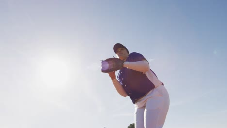 Mixed-race-female-baseball-fielder-catching-and-throwing-ball-on-sunny-baseball-field