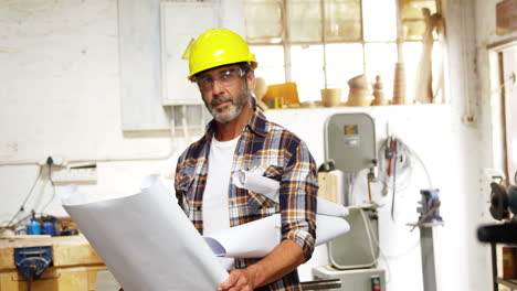 Serious-carpenter-reading-plan-and-thinking-with-hard-hat