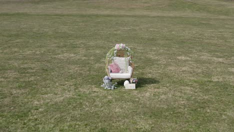 drone zoom into easter decorations on a grass field