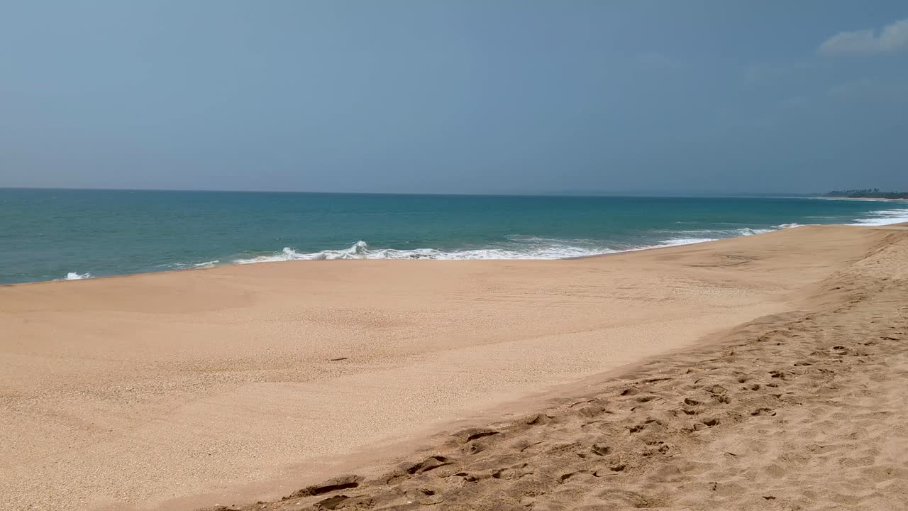 Scenic view of Rekawa Beach with white sand, blue ocean water, and no people near Tangalle, Southern Province Sri Lanka
