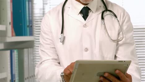 confident doctor using tablet