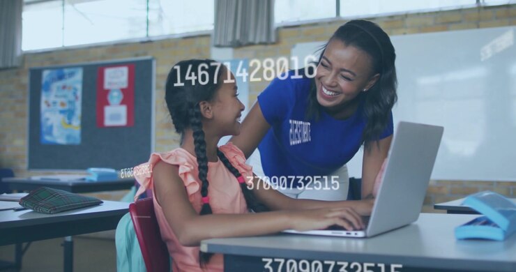 Vertical video: Teacher leaning guiding pupil typing laptop in class, data overlay showing gains