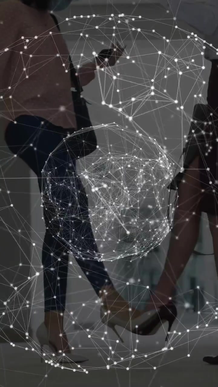 Vertical video: Two women passing in mall hall, network appearing overlaying front, checking phones