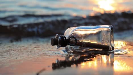 message in the bottle against the sun setting down