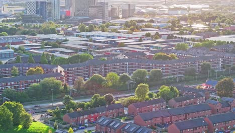 apartment buildings and street traffic in manchester, rising aerial