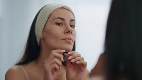 Disappointed-girl-looking-mirror-in-bathroom.-Worried-lady-checking-wrinkles