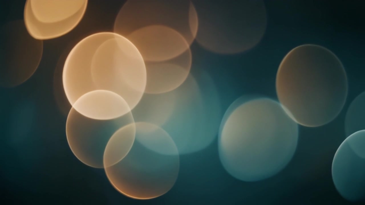 Abstrakt baggrund af blødt glødende gyldne og turkise bokeh-lys