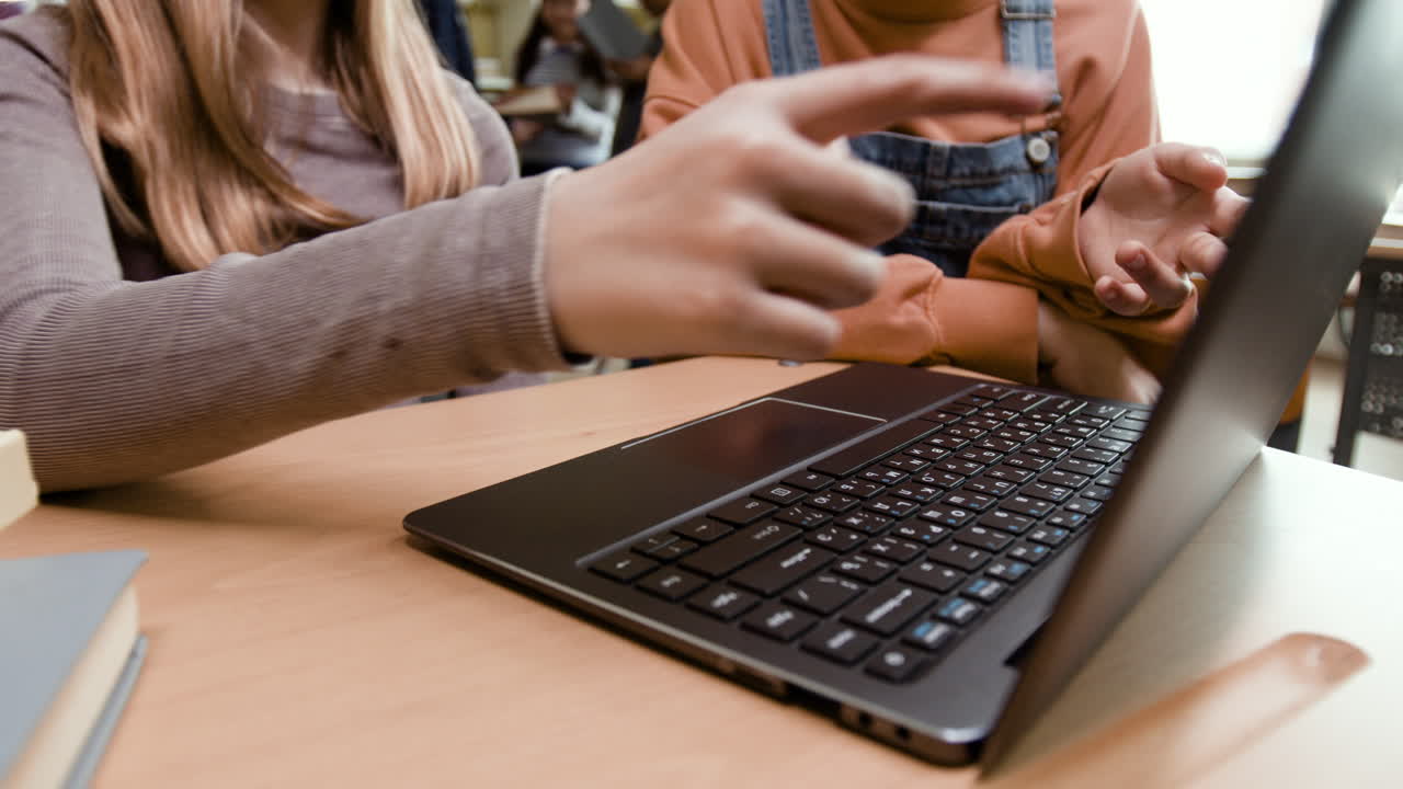Students using a laptop in a classroom