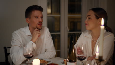 loving couple talking at romantic home evening closeup. lovers enjoying dinner