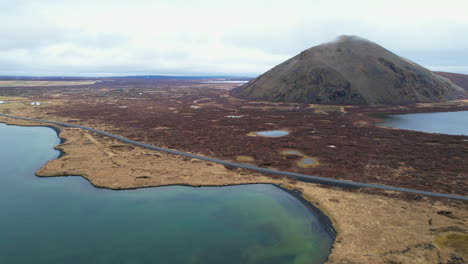 lake myvatn,vindbelgjarfjall: side aerial view of the beautiful icelandic lake and a volcano on a sunny day