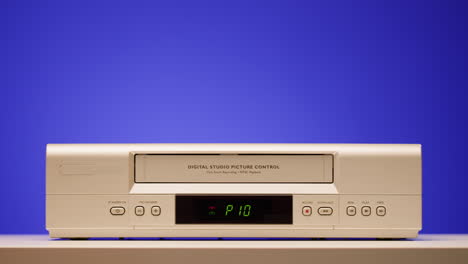vintage vcr with hand operating it