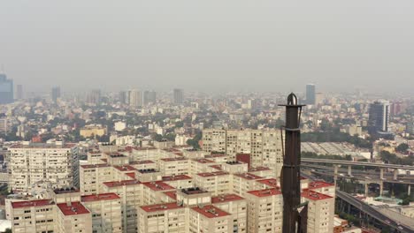 aerial shot of a big monument in a very polluted day in mexico city