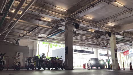 underground parking garage with motorcycles and cars