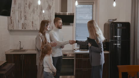 woman giving key to a family