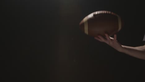 close up studio shot of american football player throwing and catching ball 1