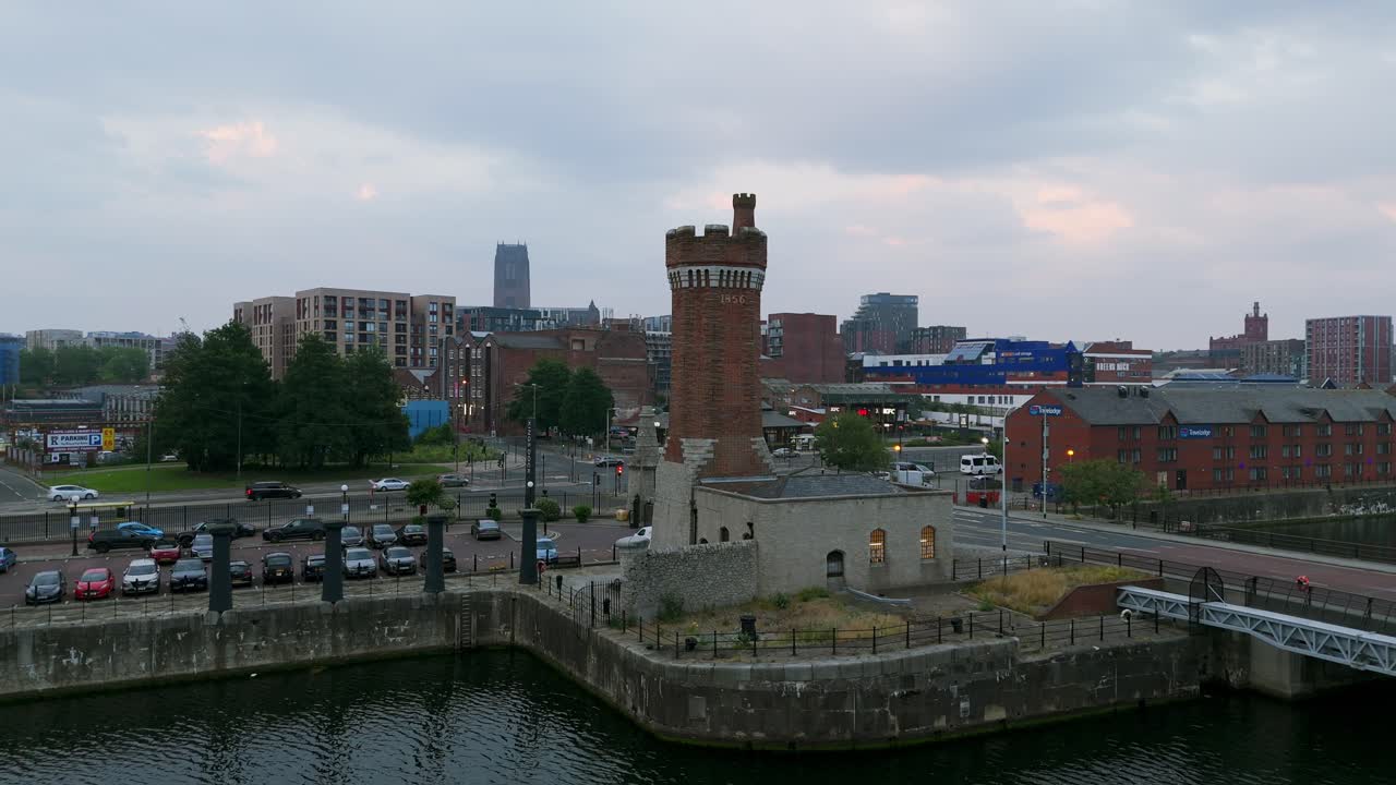 Victoria Tower at Salisbury Dock, River Mersey, and Liverpool cityscape at dusk, England, UK. Aerial backward