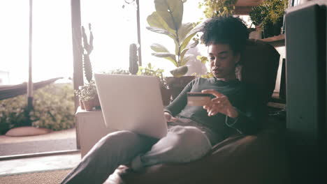 a woman holding her bank card while using