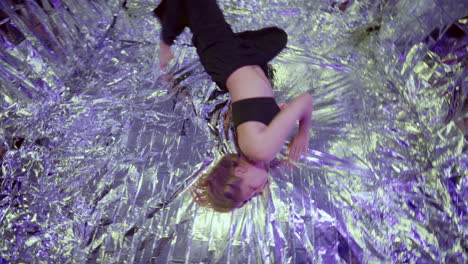 woman performing floor work on reflective surface during contemporary dance