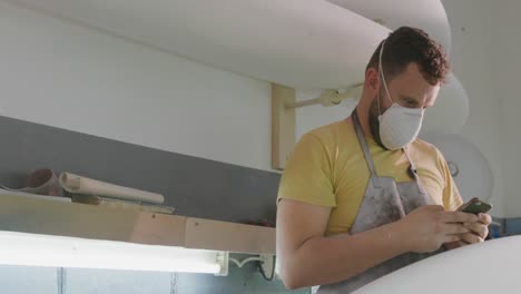 male surfboard maker in his workshop