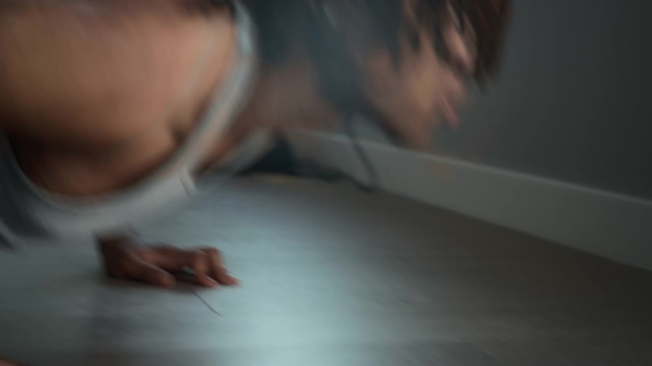 A man doing pushups in the living room at home