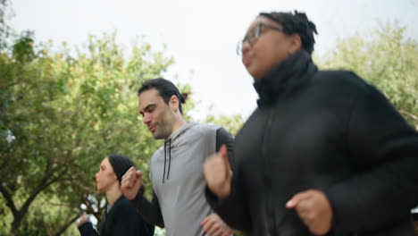 training, woods and group of friends running