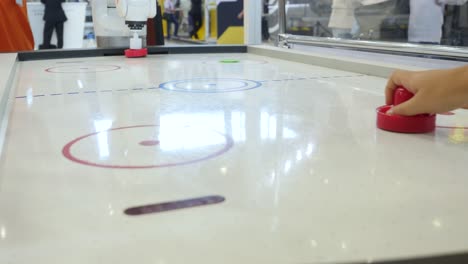 robot playing air hockey