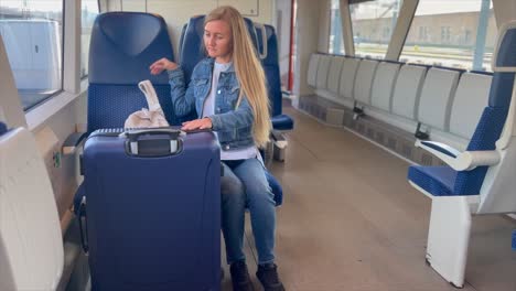 a beautiful female tourist enters a subway car with luggage. new york subway ride