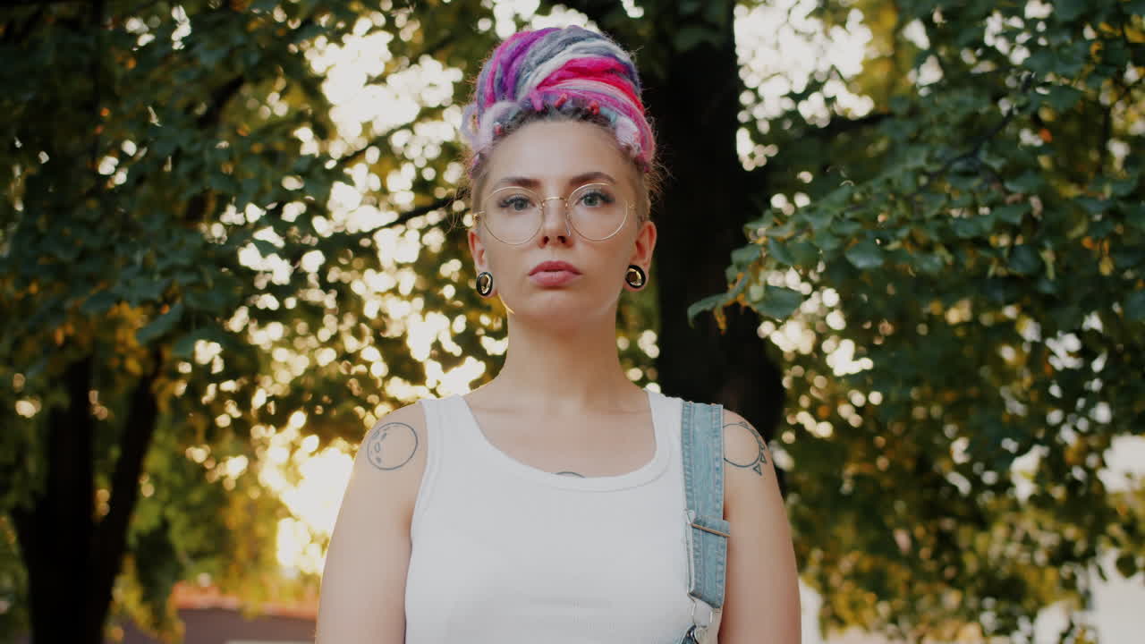 Woman with Colorful Dreadlocks and Tattoos