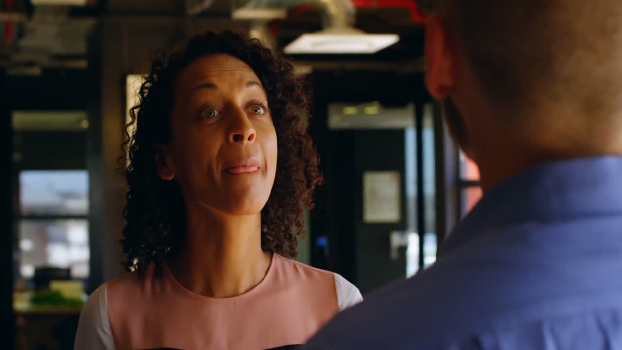 Business colleagues interacting with each other in cafeteria 4k