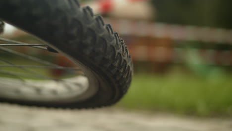 wheel of a fallen bicycle rotating, slowly coming to a halt