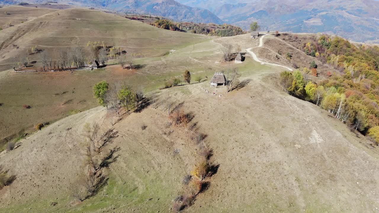 румынская отдаленная деревня с традиционными домами с соломенными крышами на холмах, осенний пейзаж