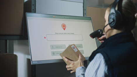 warehouse worker scanning package for delivery tracking