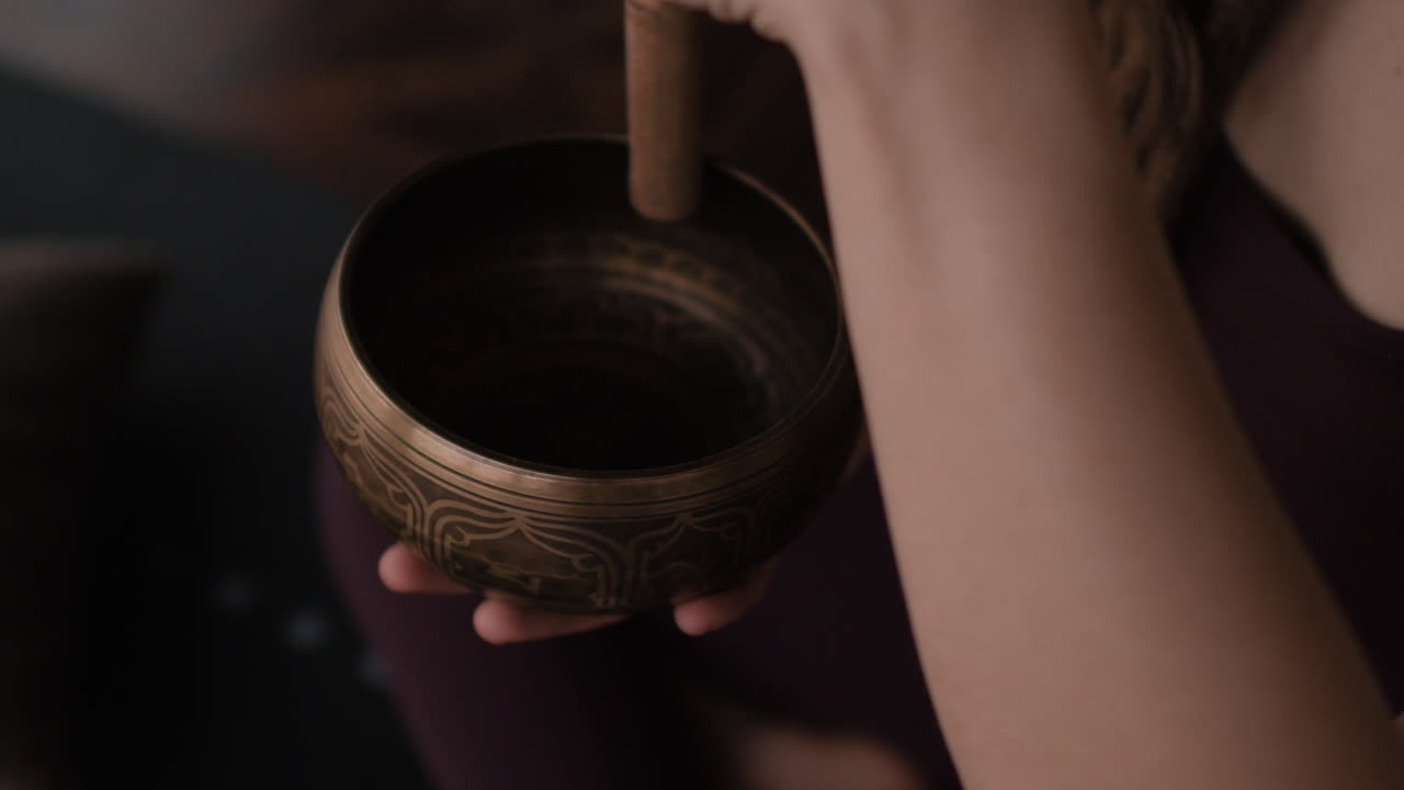 Person Playing a Singing Bowl
