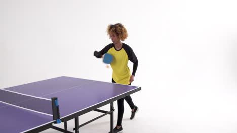 female table tennis player serving and passing the ball on white background, copy space