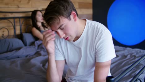 couple ignoring each other after fight in bedroom