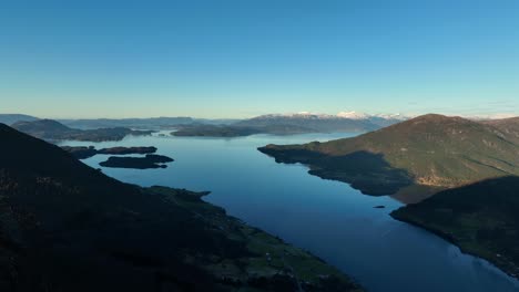 mountain aerial at sunset in western norway with views of bjoa fjord, skanevik fjord, and islands