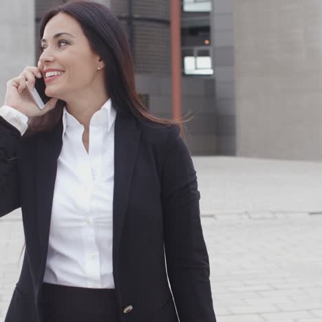 Attractive-businesswoman-checking-her-mobile-phone