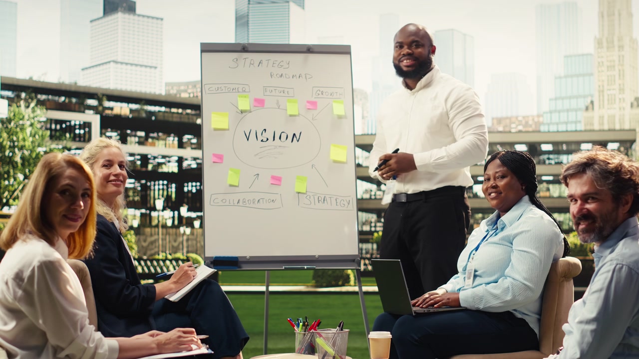 Portrait of smiling business team discussing vision board during outdoor workshop