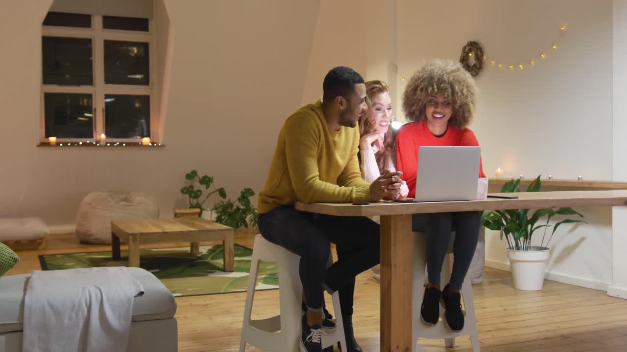 Millennial adult friends socialising together at home