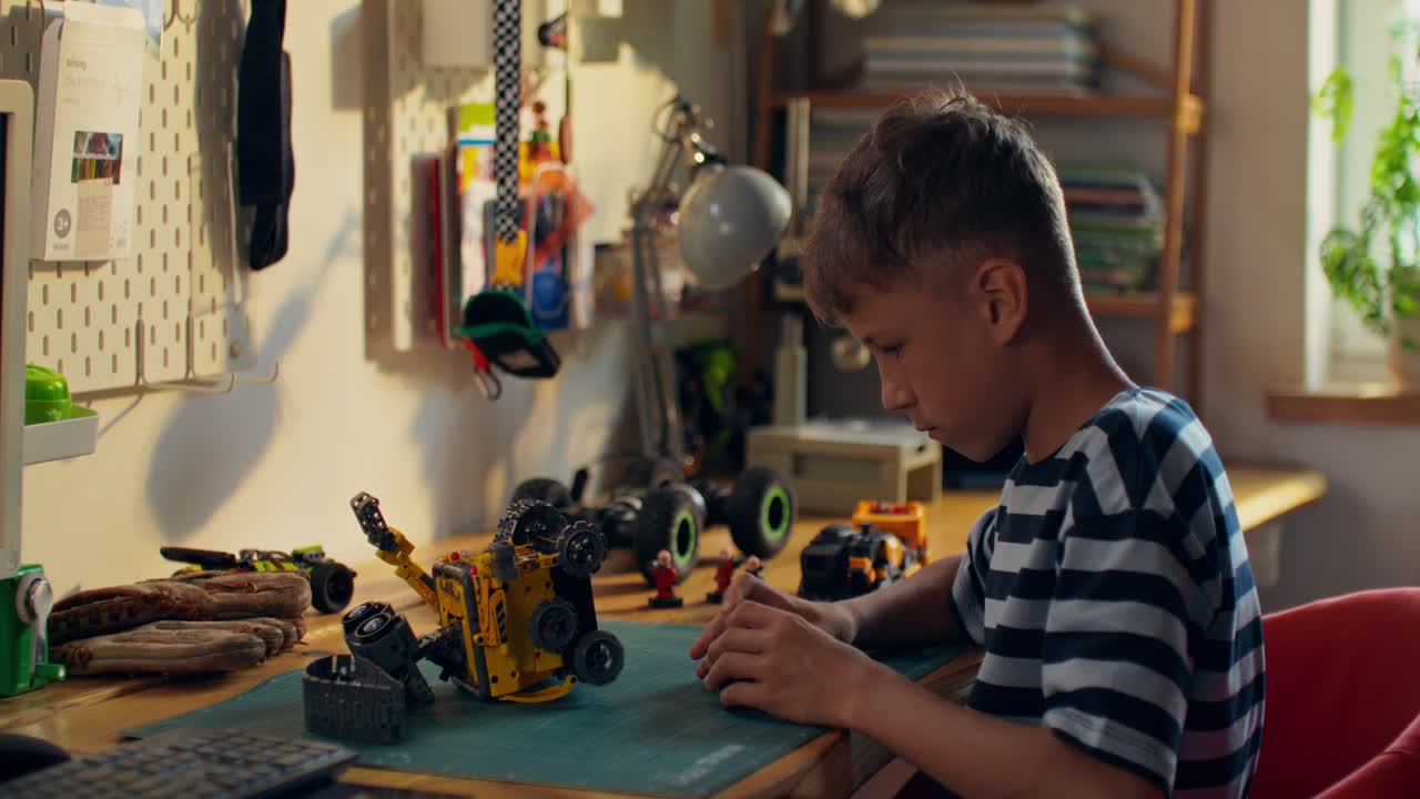 Boy Building a Robot Toy at Desk