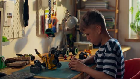 boy building a robot toy at desk