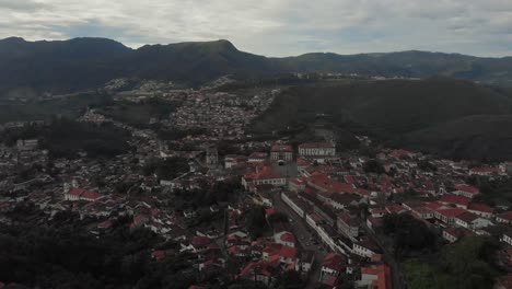 painterly aerial panorama landscape tilting to reveal the historic colonial city centre of ouro preto, minas gerais, brazil, on a hill on an overcast morning
