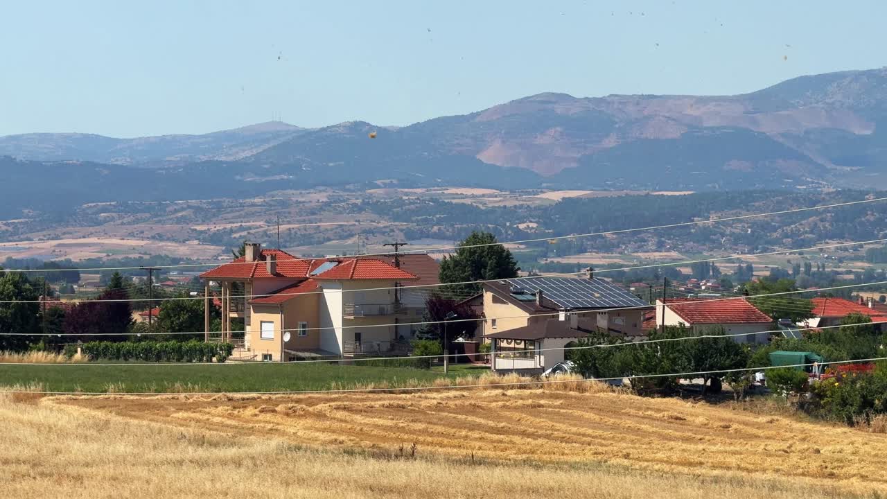 Small wind tornado dust devil Greece rural countryside village outdoor clear sky